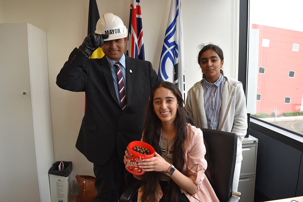 Work experience students sitting at the mayors desk.